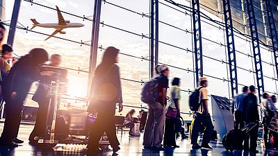 A group of people waiting at the airport to enter Germany